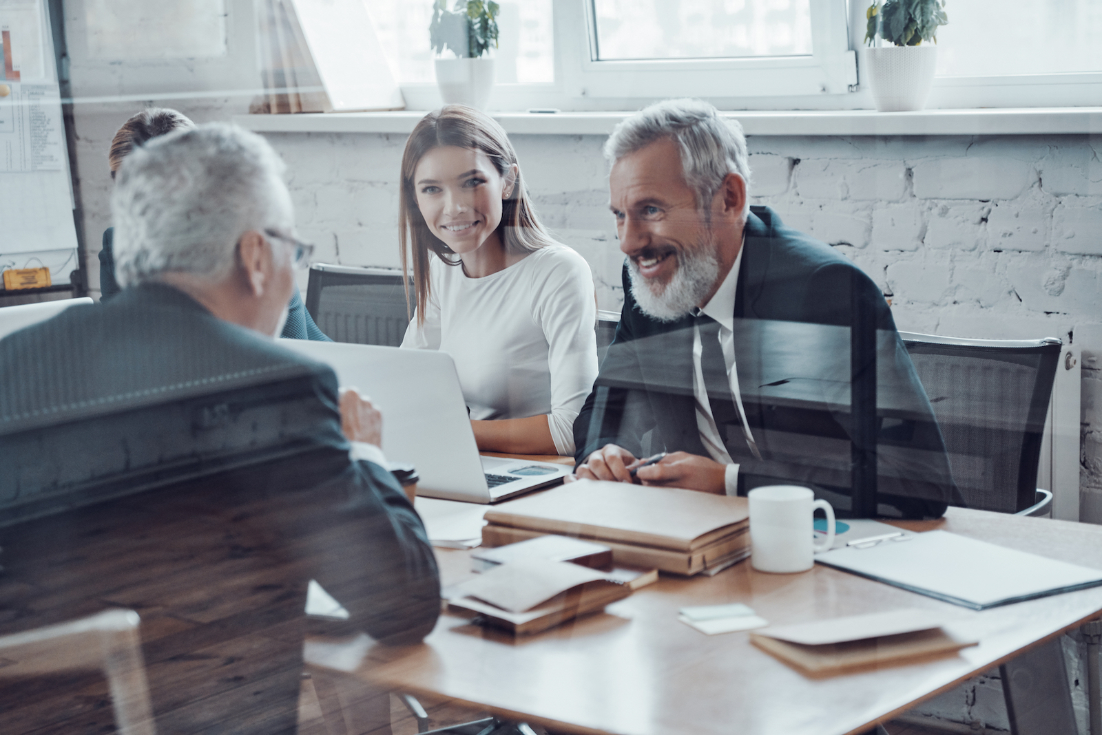 Real Estate Investor Consultant meeting with clients at office desk